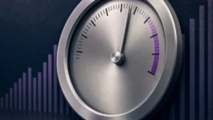 Metal scoring dial with the needle near the top of its range against a dark backdrop
